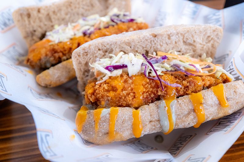 Starbird chicken sandwich with crispy coating and fresh toppings
