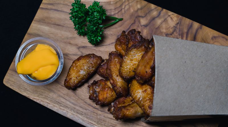 Starbird chicken tacos spread on a wooden board with toppings